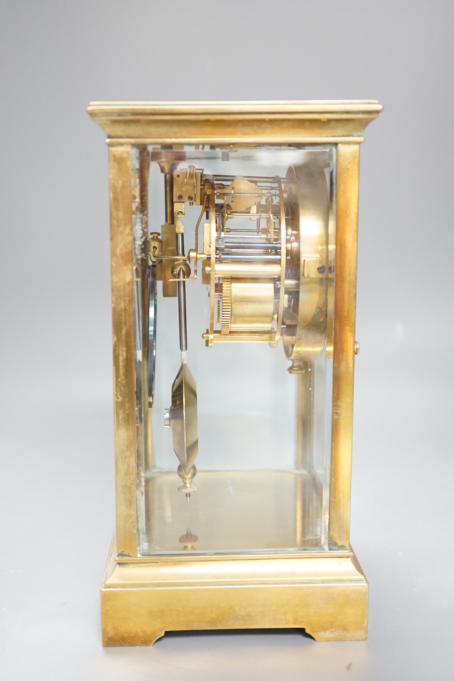 A French brass four glass mantel clock, 23cms high